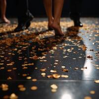A luxuriant black dance floor sparkles with golden confetti photo