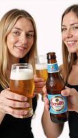 Friends toasting glasses of beer in an advertisement setting photo