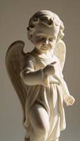 A babyangel statue is depicted in a photorealistic style with intricate details photo