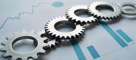 Seamlessly integrated business growth represented by abstract gears interacting with business charts photo