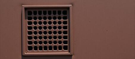 Rusty metal panel with rectangular vent circular hole pattern photo