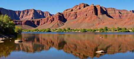 Bright sunlit day at Lees Ferry showcases the peaceful Colorado River flowing amidst Grand Canyons colorful cliffs photo