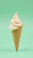 Pastelgreen backdrop featuring a solitary ice cream cone centrally placed photo