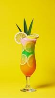 A vibrant tropicalinspired cocktail with lemon and palm leaves against a sunny yellow backdrop photo