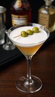 Martini with olives in classic glass perfect for barsparties or menus photo