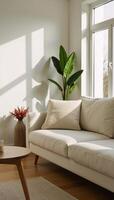A sunlit living room showcases a comfortable scene a couch potted plants and a vase filled with flowers photo