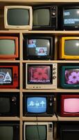 A vintage collection display showcases old televisions and antique media devices on a shelf photo