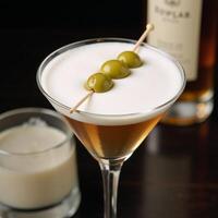 Martini with olives in classic glass perfect for barsparties or menus photo