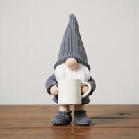 Adorable gnome figurine grayclad mugholding stands on wooded surface photo