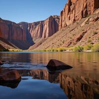 Bright sunlit day at Lees Ferry showcases the peaceful Colorado River flowing amidst Grand Canyons colorful cliffs photo