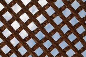 Texture of old wooden gate in metal frame. Background photo