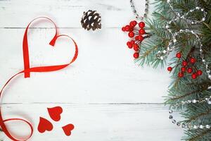 Valentine's day background, hearts and branches of a Christmas tree on a white tree. place for text. top view photo