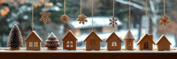 Winter decorations featuring wooden houses and snowflakes hanging in a cozy indoor setting photo