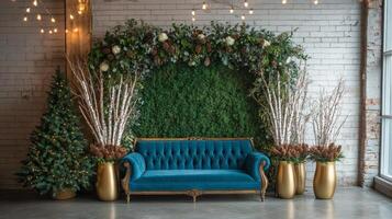 Festive blue sofa surrounded by greenery and holiday decorations in a seasonal indoor setting photo