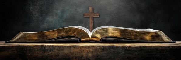 An open Bible resting on a wooden surface with a cross illuminated by soft light photo