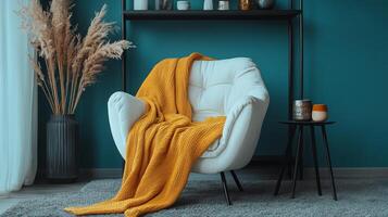 Cozy modern living room with a stylish chair and vibrant throw in a serene blue interior setting photo