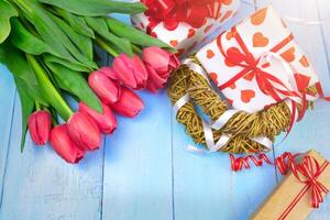 Spring background. Bouquet of flowers on a wooden background and a nest with eggs. spring photo