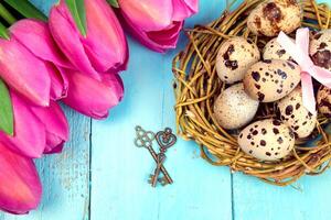 Spring background. Bouquet of flowers on a wooden background and a nest with eggs. spring photo