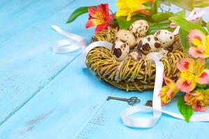 Spring background. Bouquet of flowers on a wooden background and a nest with eggs. spring photo