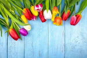 Bouquet of tulips on blue wooden table. Happy women's day. 8 March., Mother's Day. photo