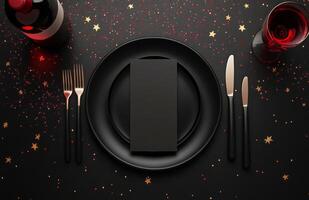 Elegant dinner setting with red wine, black plate, and golden cutlery on a dark table photo