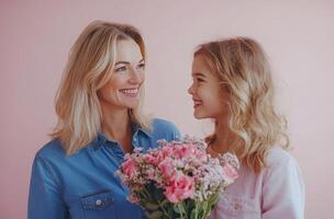 A joyful mother and daughter share a special moment with pink flowers against a pastel background photo
