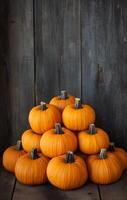 Arrangement of vibrant orange pumpkins on a dark wooden surface in autumn decor photo