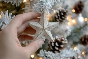 Decorating a festive tree with a handmade star ornament during the holiday season photo