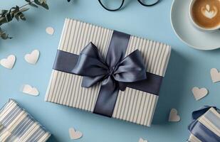 A beautifully wrapped gift with a navy bow surrounded by heart-shaped decorations on a table photo