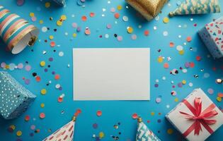 Colorful party decorations and supplies arranged on a blue background with a blank card photo