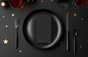 Elegant dinner setting with red wine, black plate, and golden cutlery on a dark table photo