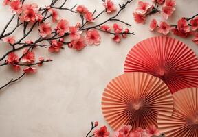 Elegant red folding fan accompanied by blossoming cherry branches on a soft background photo