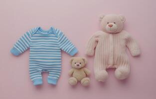 Sweet baby clothes and toys arranged on a soft pink background for a charming nursery display photo