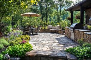 A serene garden patio with a dining area and grill, surrounded by lush greenery in daylight photo