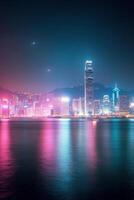 Vibrant nighttime skyline of Hong Kong with colorful lights reflecting on the water photo