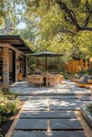 Cozy outdoor dining area with an umbrella surrounded by greenery in a serene backyard setting photo