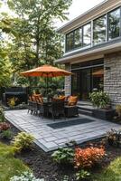 Cozy outdoor dining area with an umbrella surrounded by greenery in a serene backyard setting photo