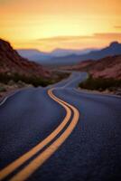 Scenic highway winding through mountains at sunset with vibrant sky and soft shadows photo
