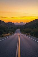 Scenic highway winding through mountains at sunset with vibrant sky and soft shadows photo