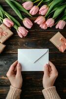 Celebrating a special occasion with gifts and fresh tulips on a gray surface in cozy attire photo