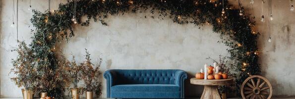 Cozy autumn decorations with a teal couch, pumpkins, and greenery in a warm setting photo