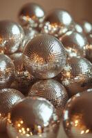 Shiny disco balls piled together in a festive setting ready for a party celebration photo