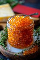 Fresh salmon roe served in a jar with herbs on a wooden board during daylight hours photo
