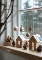 Wooden decorations and miniature houses create a cozy winter atmosphere by the window photo