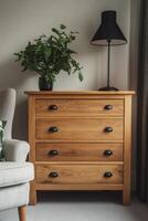 Elegant wooden chest of drawers beside a stylish lamp and indoor plant in a cozy living room photo