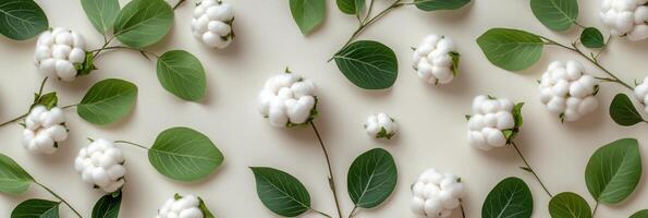 Cotton bolls and green leaves arranged aesthetically on a light background for floral decoration photo
