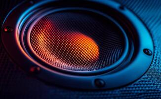 Colorful close up of a speaker cone illuminated by vibrant LED lights at a sound event photo