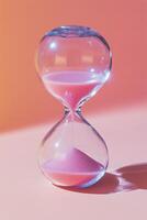 Elegant hourglass with pink sand on a vibrant pink backdrop, emphasizing the passage of time photo
