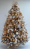 Festively decorated Christmas tree with gold ornaments in a cozy living room setting photo