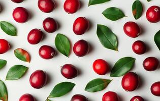 Fresh cranberries and green leaves arranged on a light background in an artistic display photo